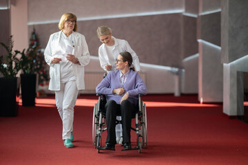 Doctor checking patients progress in wheelchair