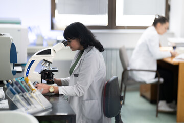 Doctor scientist using microscope in laboratory