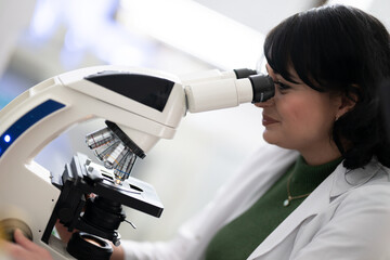 Doctor scientist using microscope in laboratory