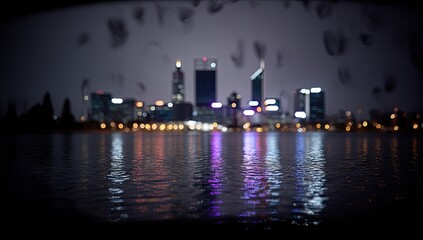 Fototapeta premium City skyline reflected in water at night.