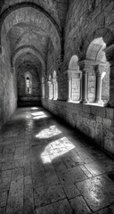 Fototapeta premium Interior corridor with arched windows and sunlight.