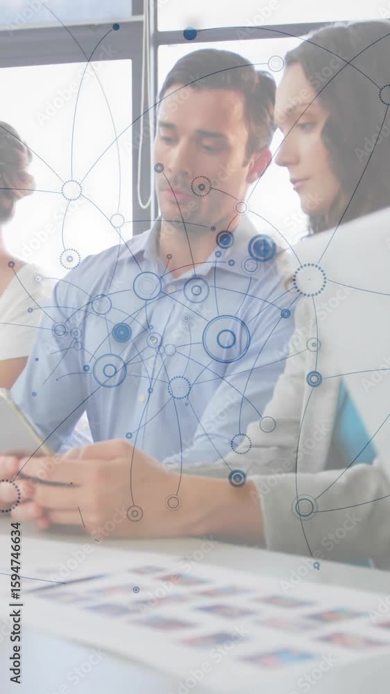 Poster collaborating in modern office, business team using digital network animation overlay