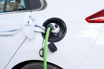 Close up of the Hybrid car electric charger plugged into an electric car being charged