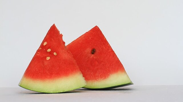 Someone's hand takes a slice of watermelon (Citrullus lanatus), eat it, and put it back.