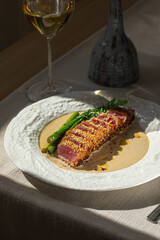 Grilled sliced tuna with asparagus and sesame in creamy sauce