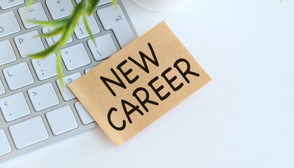 A keyboard with a piece of paper that says New Career on it