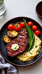 a plate of ribeye steak with herb butter, grilled zucchini, cherry tomatoes, and mashed potatoes, overhead food styling, elegant presentation on dark ceramic plate, soft directional light