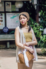 Beautiful Asian woman smiling in outdoor scene, vintage tone.