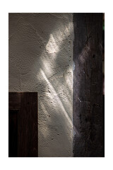 Diagonal Light Beam Passing Through a Stone Wall with Windows, Contrast - Light and Dark.