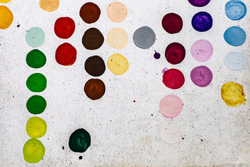 Multicoloured hand painted spots, dots, polka dots or circles on canvas. Grey background. Modern decorative contemporary artwork painting. Random abstract background design pattern and texture.