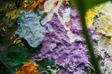 A painting with a variety of colors and textures. The painting is a mix of blue, green, red, and...