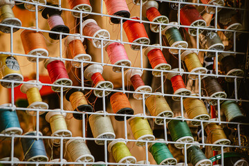 multicolored threads and ribbons. Background for the store selling reels with ribbons. materials for sewing and creativity. Fashionable craft of women.