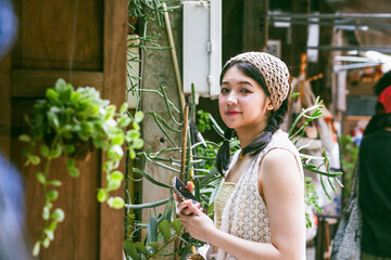 Beautiful Asian woman smiling in outdoor scene, vintage tone.