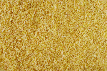 Raw bulgur wheat grains background. Healthy eating concept. Vegan and vegetarian food. Diet. Horizontal orientation. Top view.