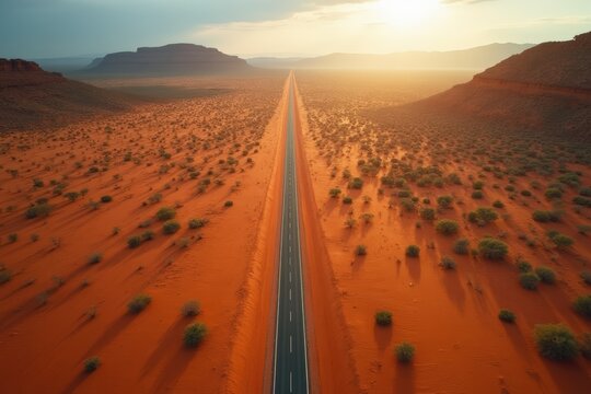 Aerial view of isolated man-made road through desert, highlighting human intervention in this remote landscape, Australia. - Powered by Adobe