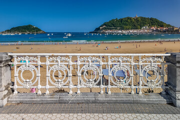 La Concha Beach with turquoise sea and iconic white fence in Donostia Spain
