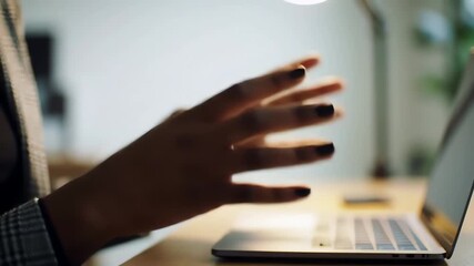 Businesswoman hands using virtual interface with gesture control over a laptop in a modern office - Powered by Adobe