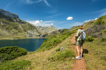 Woman Hiking by Calabazosa Lake, Somiedo Park, Summer in Asturias, Spain