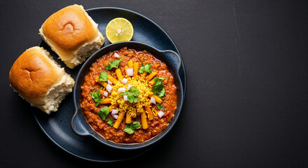 Top-down flat lay of traditional Indian Misal Pav in a ceramic bowl with copy space