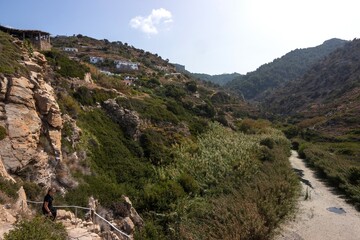 Trail down to the beautiful  Nas beach with impressive canyon view with river Chalares  and cute vacation homes.