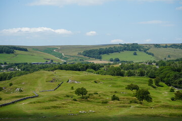 Scenic view of rolling green hills and stone walls at Solomons Temple, The Peak District, England.