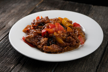 Stir Fried Eel with Vegetables on wooden background. Chinese food. Asian cuisine