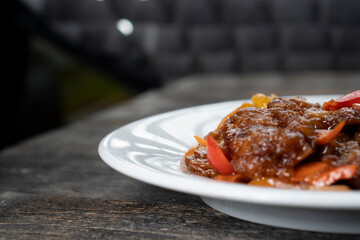 Stir Fried Eel with Vegetables on wooden background. Chinese food. Asian cuisine