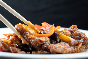 Stir Fried Eel with Vegetables on wooden background. Chinese food. Asian cuisine