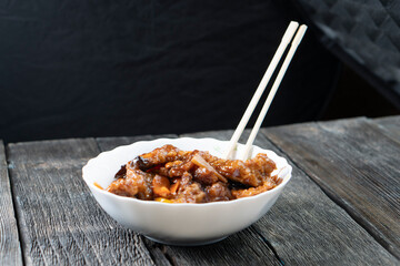 Stir Fried Eel with Vegetables on wooden background. Chinese food. Asian cuisine