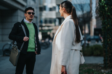 Two young people holding a discussion outdoors in a modern urban environment. Showcases a casual...