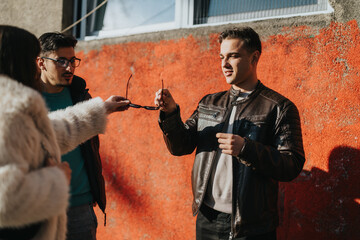 Friends gathered in a city setting, sharing moments of connection and interaction during a sunny...