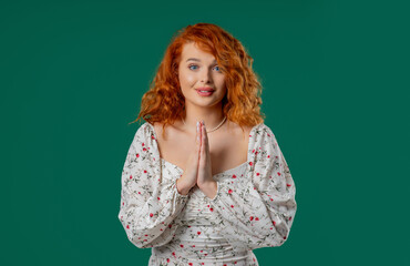 Ginger-haired woman praying with palms in sincere silent request. Hope, faith