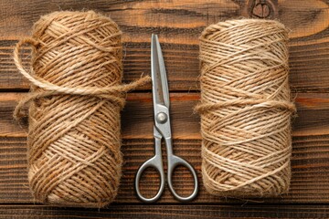 Overhead view of a coiled rough rope and scissors on a wooden surface for crafting projects