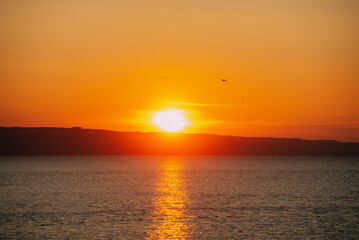 A stunning sunset casts golden hues over calm waters, creating a perfect atmosphere for relaxation...