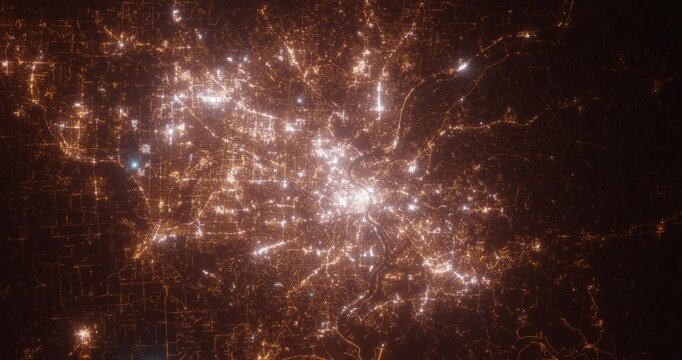 Cincinnati (Ohio, USA) top view at night. View on modern city from satellite. Camera is zooming in, rotating counterclockwise. Vertical video. The north is on the left side