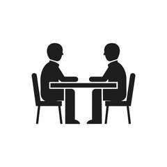 Two people sitting at a table discussing on a white background