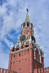 Moscow Kremlin’s Spasskaya Tower with Historic Clock Faces and Red Star Finial against a...