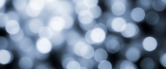 Fototapeta premium Abstract blurred lights create a bokeh effect with white and blue tones, offering a cool and clean look suitable for digital visuals, medical content, or calming modern compositions.