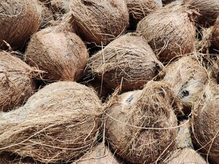 Close-Up of a Pile of Brown Coconuts with Textured Shells