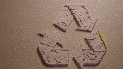 Eco-friendly emblem crafted from foliage on repurposed paper symbolizing sustainability