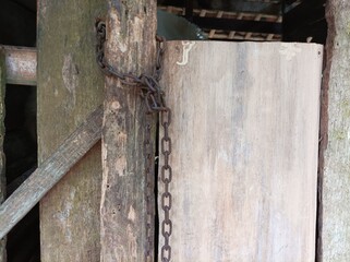 Old door with rusty chain
