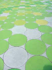 Ground Surface with Repeating Large Green and Yellow Circle Pattern