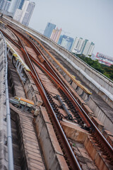 Naklejka premium Elevated BTS Skytrain Tracks Curving Through Bangkok Cityscape