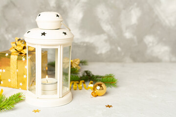 Beige christmas lantern with decorations on wooden table