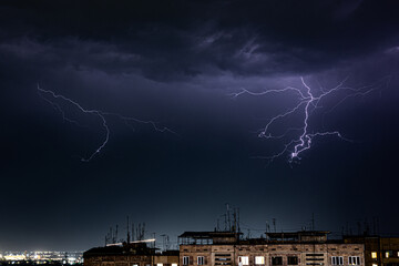 Night Cityscape with Thunderstorm, Rain and Lightning Strike