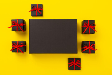 Mock up space with black gift boxes on color background, top view.Black Friday concept