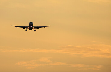 Plane flying with clearly sky at sunset
