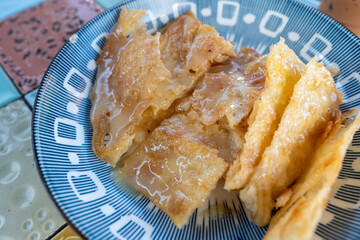 Crispy roti with condensed milk and sugar in a southern Thai snack