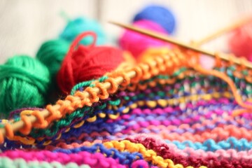 Knitting process and multicolor canvas and clews balls yarn different colors photo 