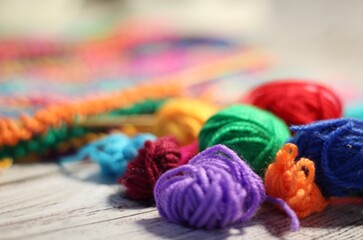 Knitting process and multicolor canvas and clews balls yarn different colors photo 